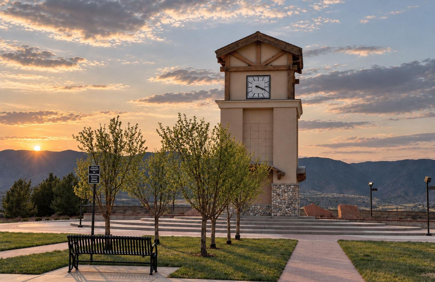 Monument clock tower, walking paths, and mountain views in the evening