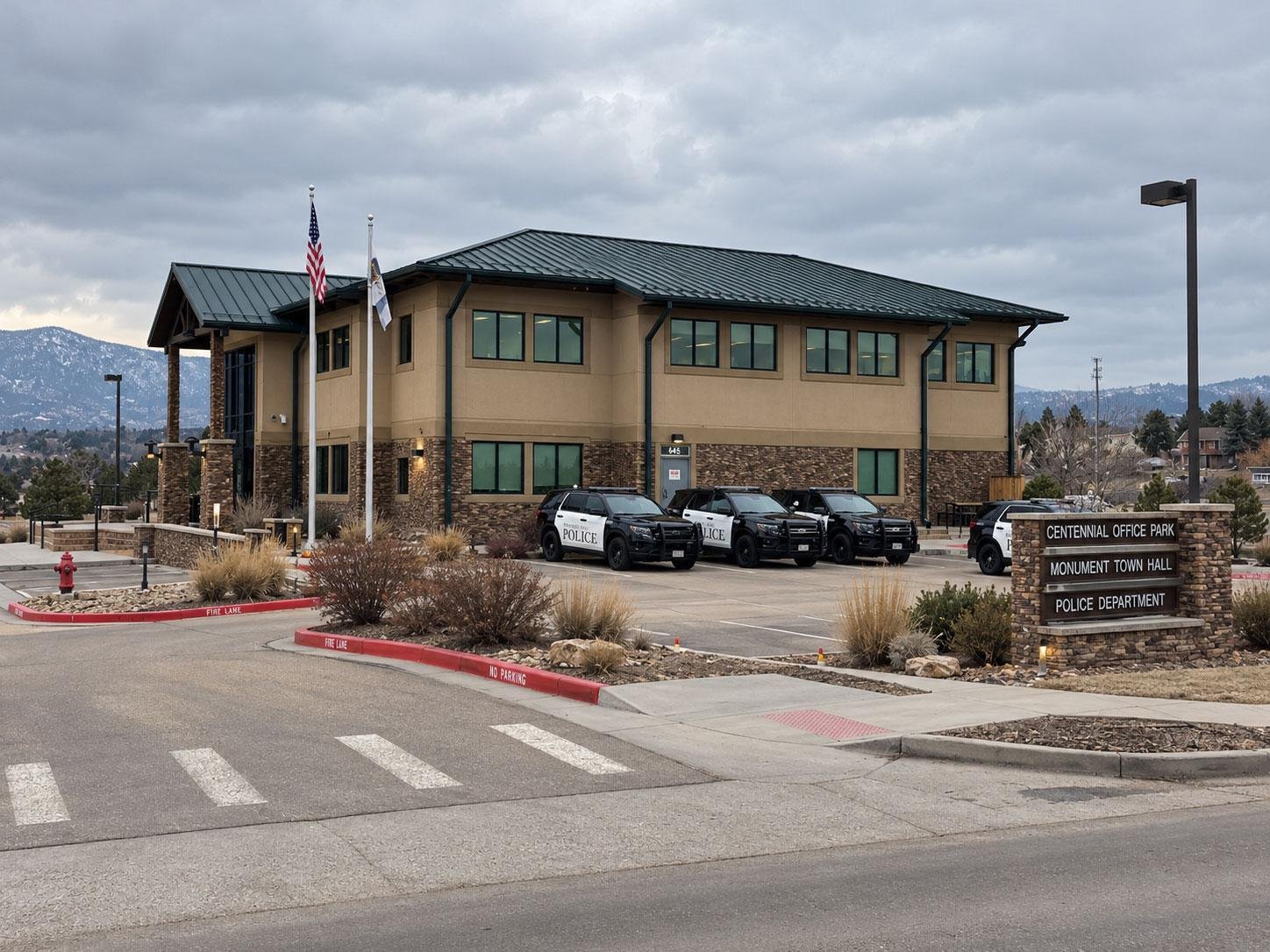 Monument Police Department building under gray skies