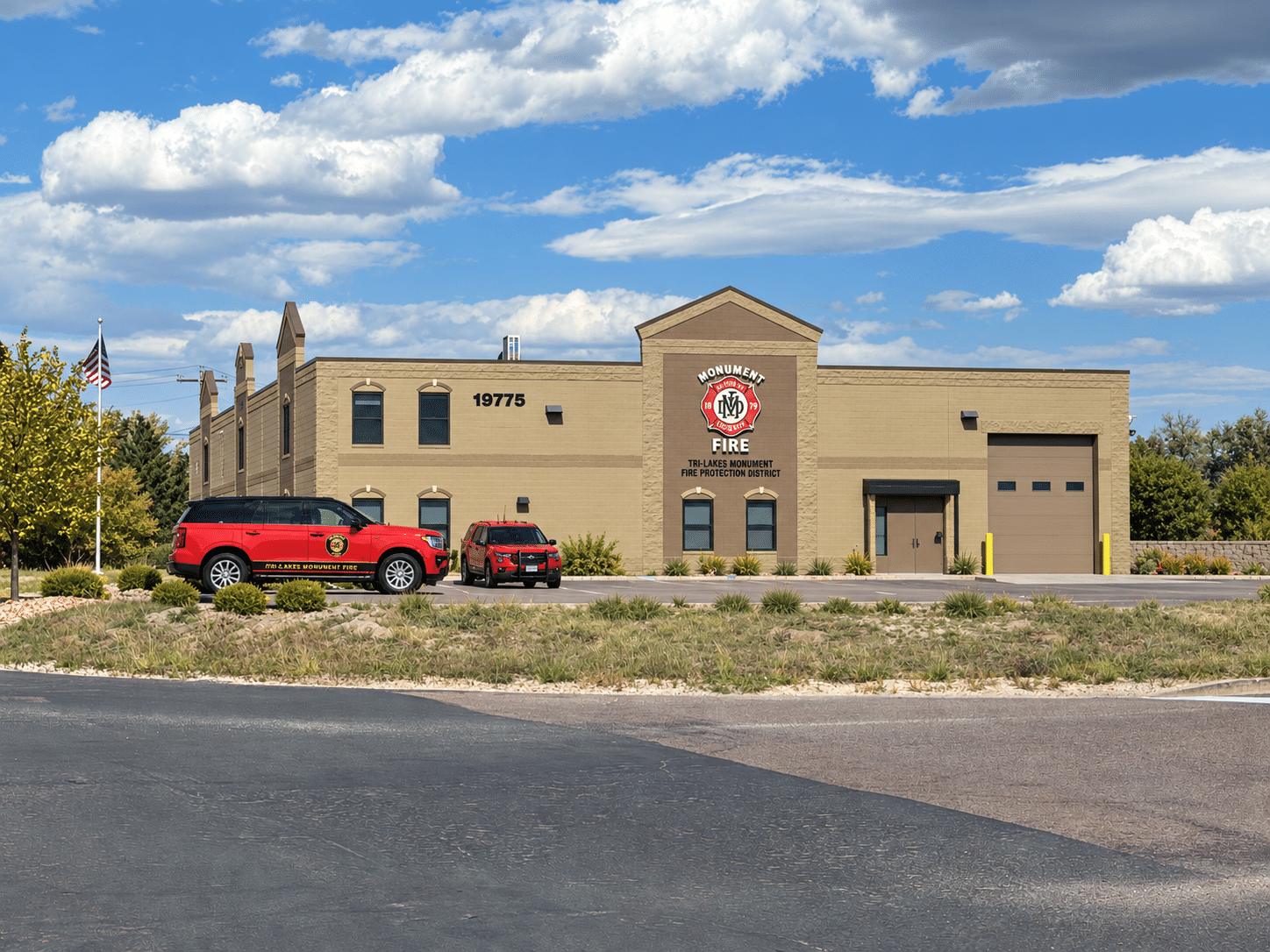 Monument-area fire station building under blue skies.
